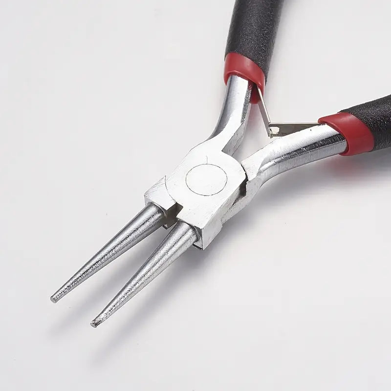 Pair of pliers with red and black handles