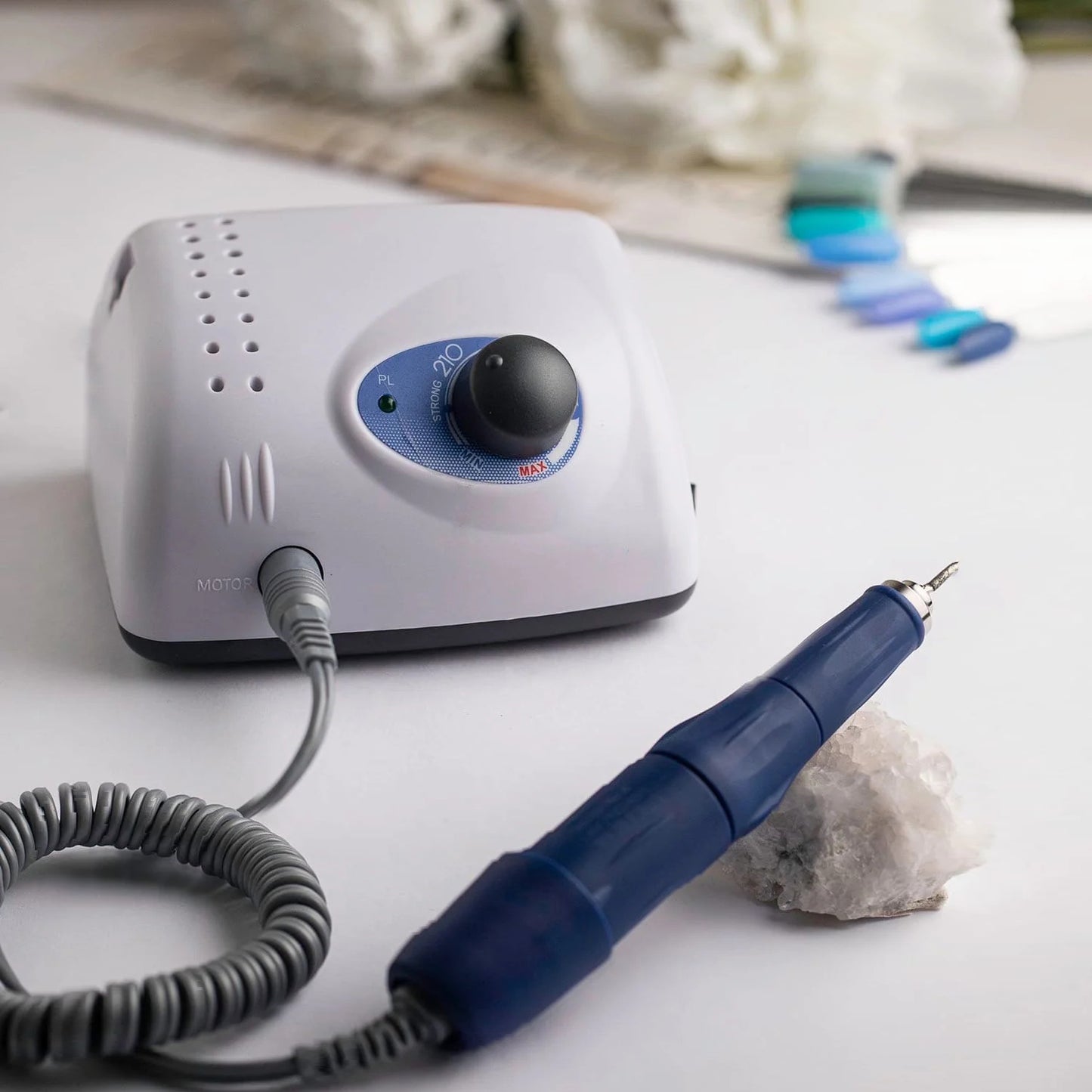 Strong 210K micromotor used by jewelry maker at workbench with 108L handpiece