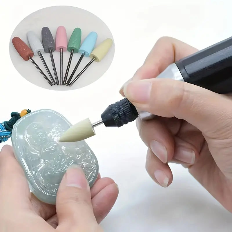 Polishing a carved jade pendant using a silicone rubber bit attached to a rotary tool