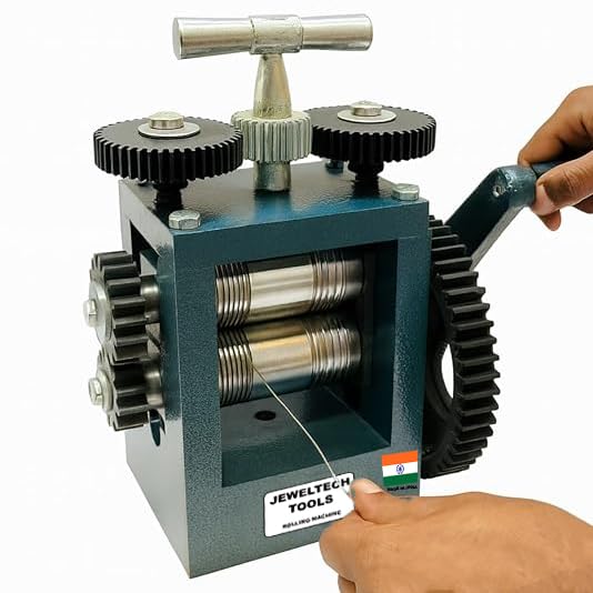 Hand using Jeweltech 4 Inch Rolling Mill Machine for rolling silver wire in jewellery making workshop