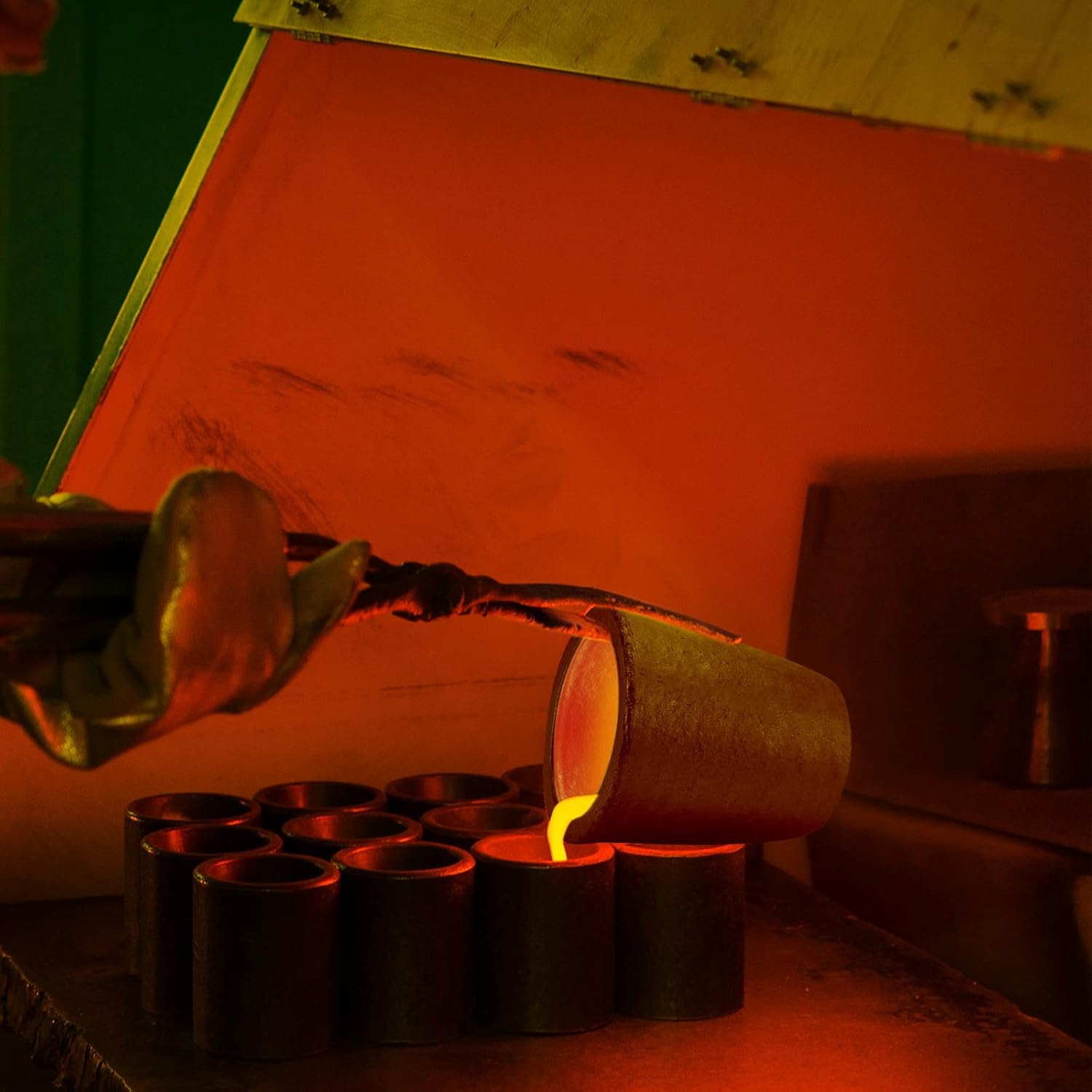 Industrial crucible pouring molten metal inside a furnace, demonstrating safe handling and high-temperature operation.