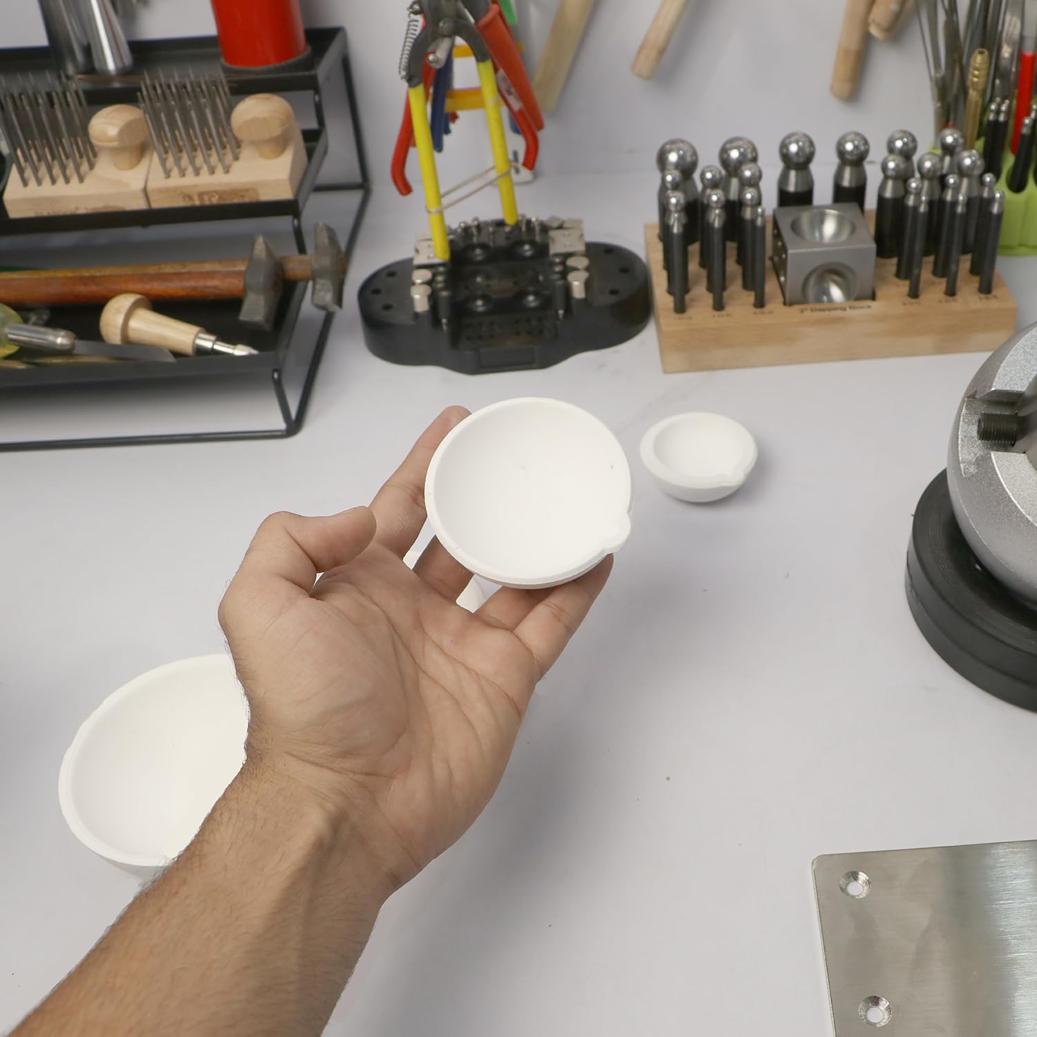 Crucible bowl with silver pieces under flame for metal casting