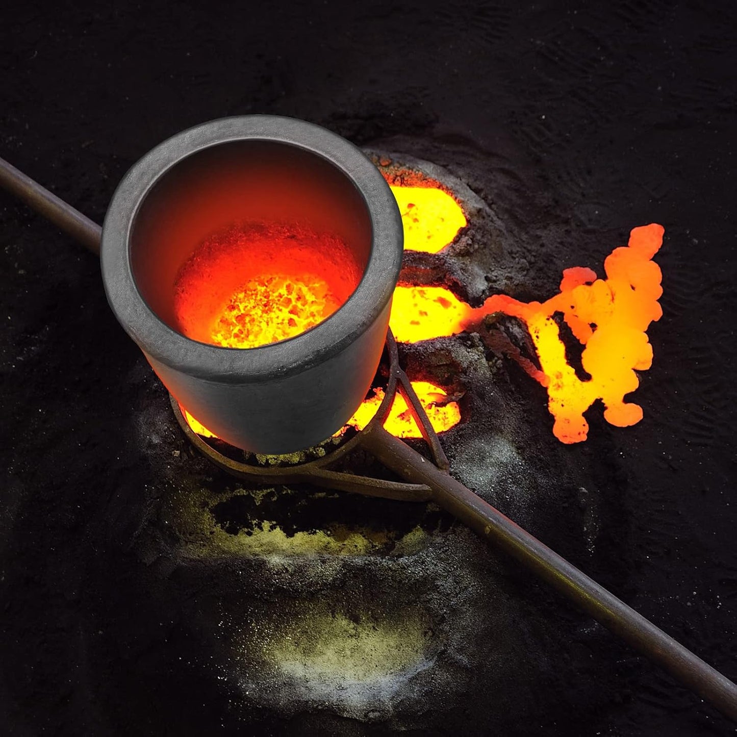 Top view of hot graphite crucible filled with molten metal, depicting intense heat and industrial smelting activity.