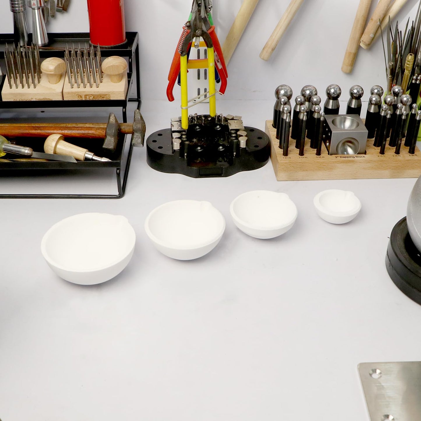 Jeweler using ceramic crucible with gas torch for refining metals