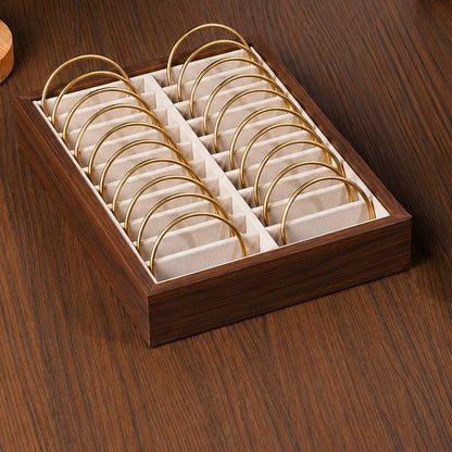 Wooden jewelry box with gold rings on a wooden surface