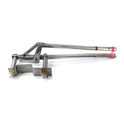 Metallic tool with springs and components on a white background