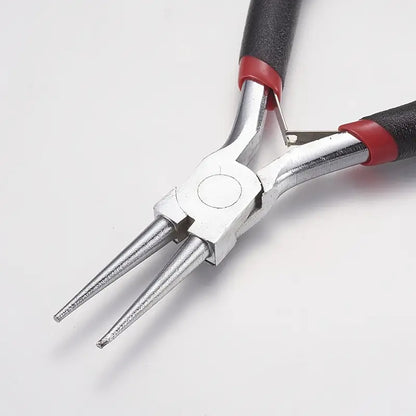 Pair of pliers with red and black handles 