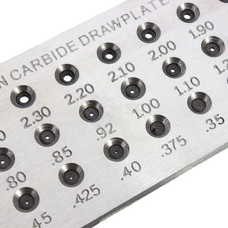 Close-up of tungsten carbide drawplate hole sizes etched in mm for accurate jewelry wire drawing