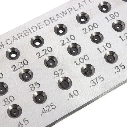 Close-up of tungsten carbide drawplate hole sizes etched in mm for accurate jewelry wire drawing